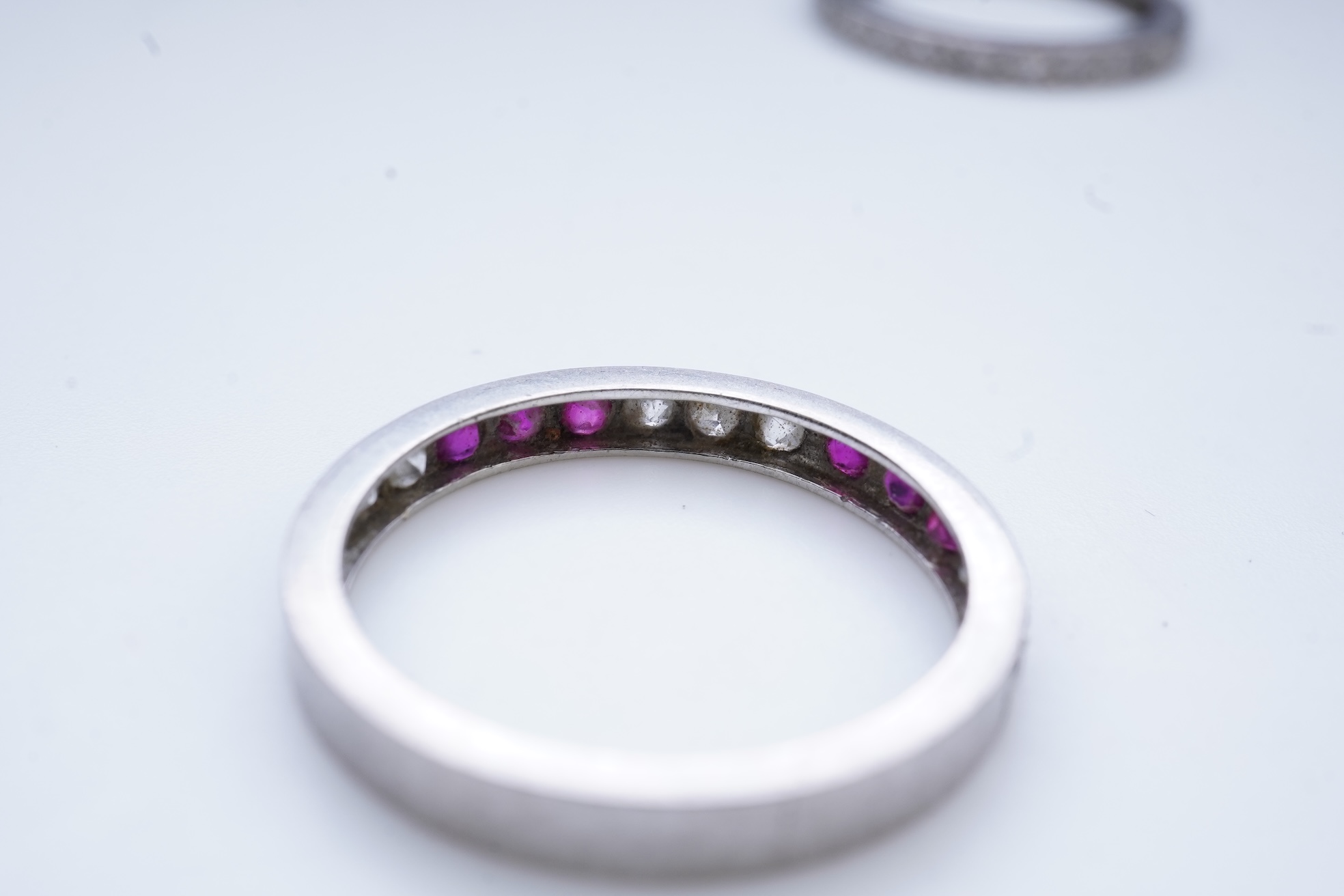 A diamond eternity ring and a ruby and diamond half eternity ring, mid 20th century